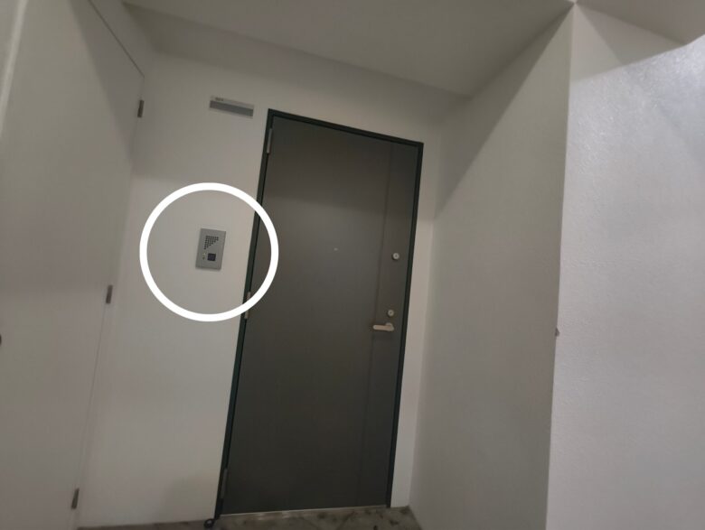 501号室のドア。横にあるインターホンを白丸で強調。